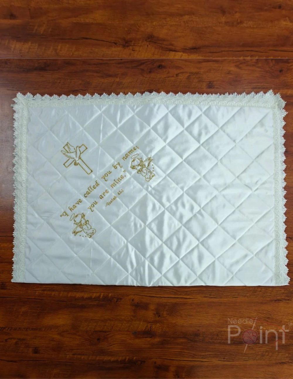 Full customisable baptism quilt showing lace border, angled flat lay view on wood surface
