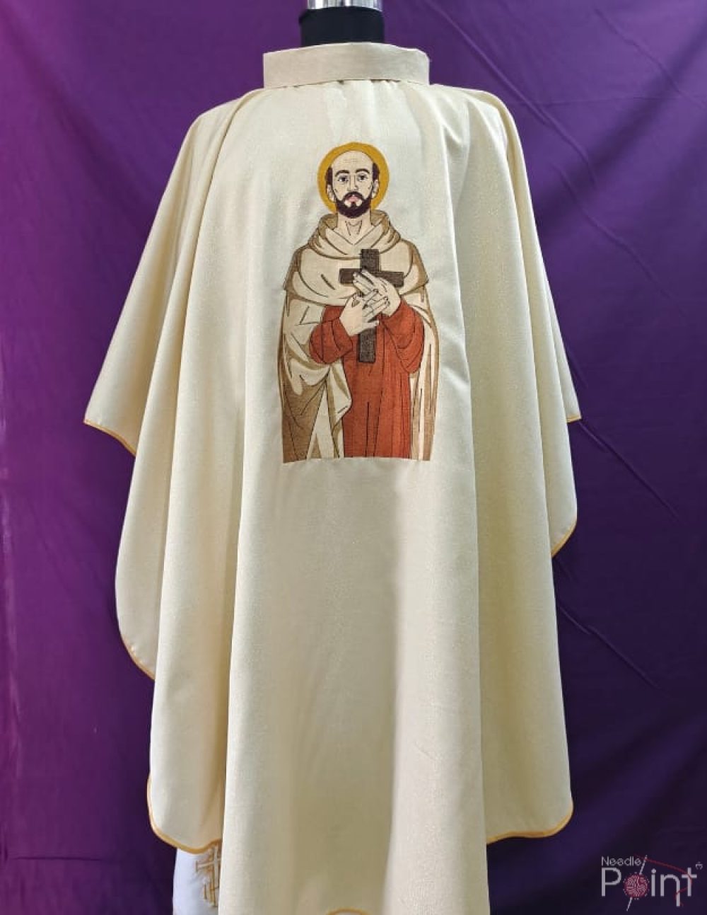 Cream chasuble front view with St John of the Cross embroidery on purple background Catholic vestment Needle Point